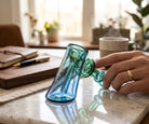 King Pluto 5-inch glass hammer bubbler pipe with blue and green gradient finish on a marble table.